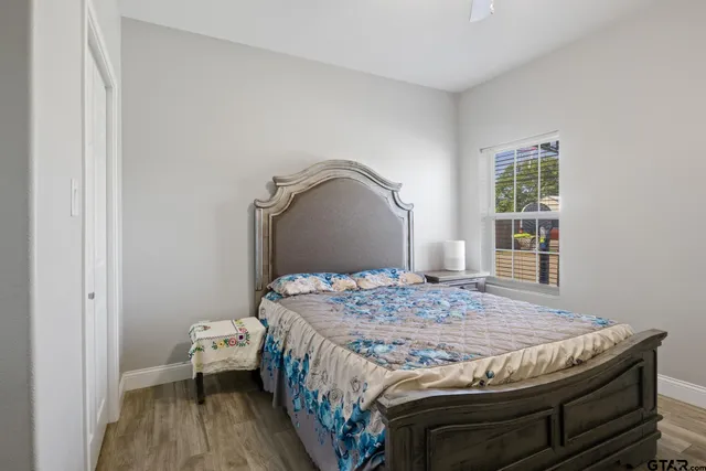 a bedroom with a bed and wooden floor