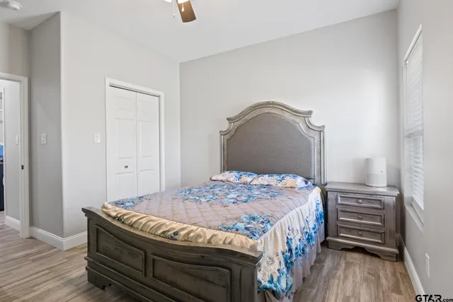 a bedroom with a bed and wooden floor