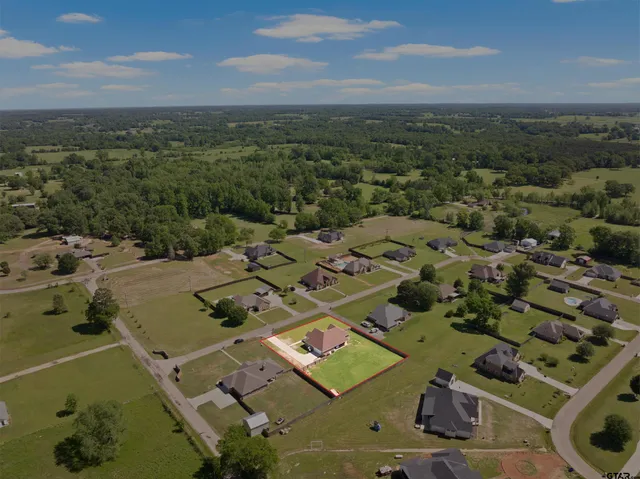 an aerial view of a residential houses with outdoor space