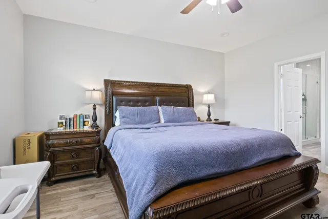 a bedroom with a bed and a chandelier