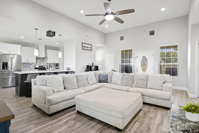 a living room with furniture and kitchen view