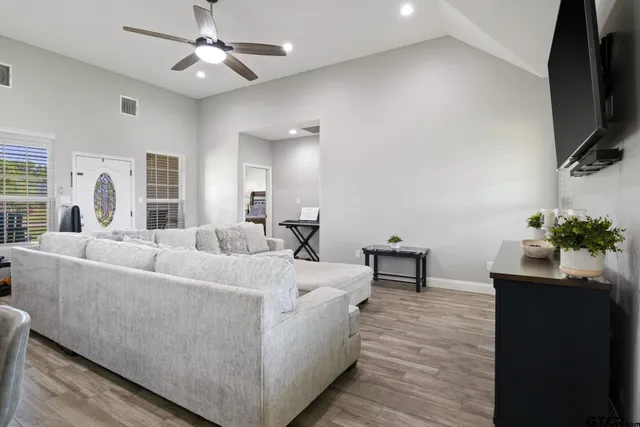 a living room with furniture and a flat screen tv