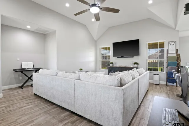 a living room with furniture and a flat screen tv
