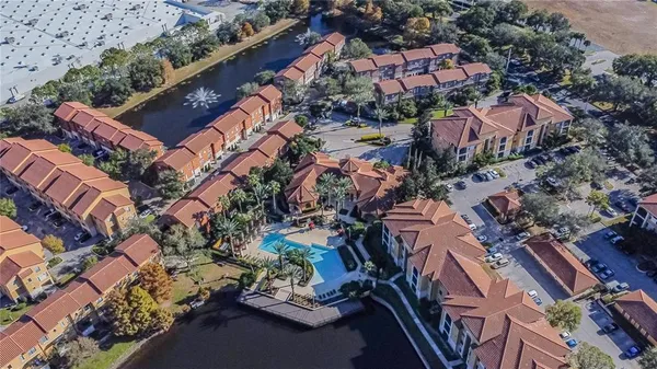 an aerial view of multiple houses with yard