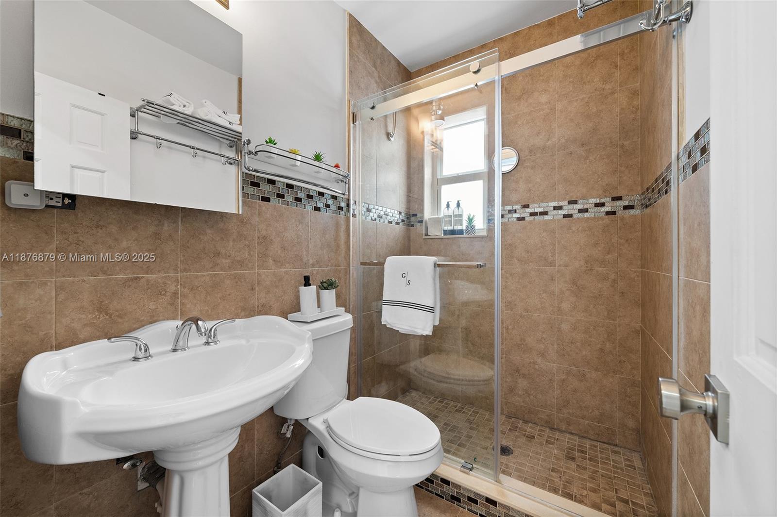 642 86th Street Miami Beach, FL 33141 - Photo 11 of 48 a bathroom with a sink toilet and shower