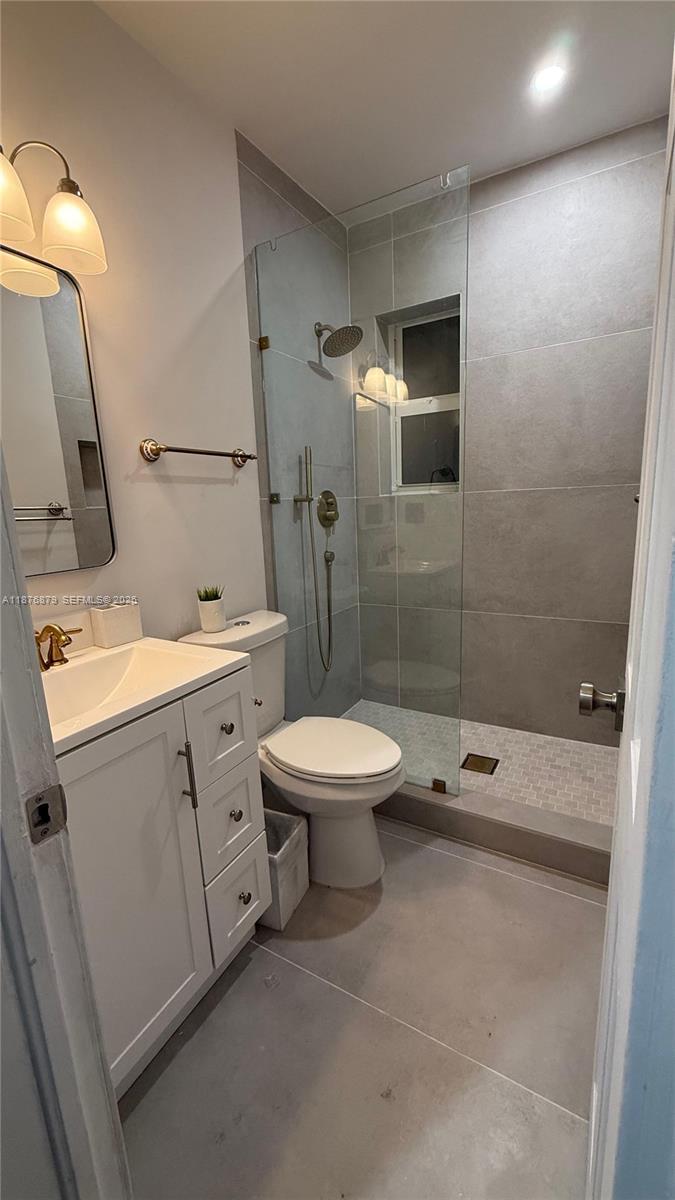 642 86th Street Miami Beach, FL 33141 - Photo 12 of 48 a bathroom with a toilet sink and shower