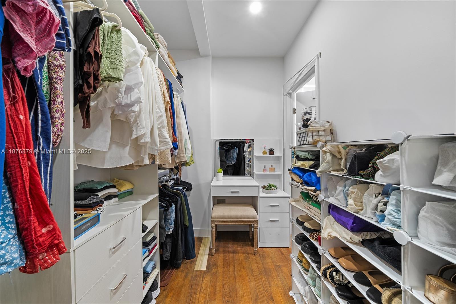 642 86th Street Miami Beach, FL 33141 - Photo 13 of 48 a view of walk in closet with clothes and shoes