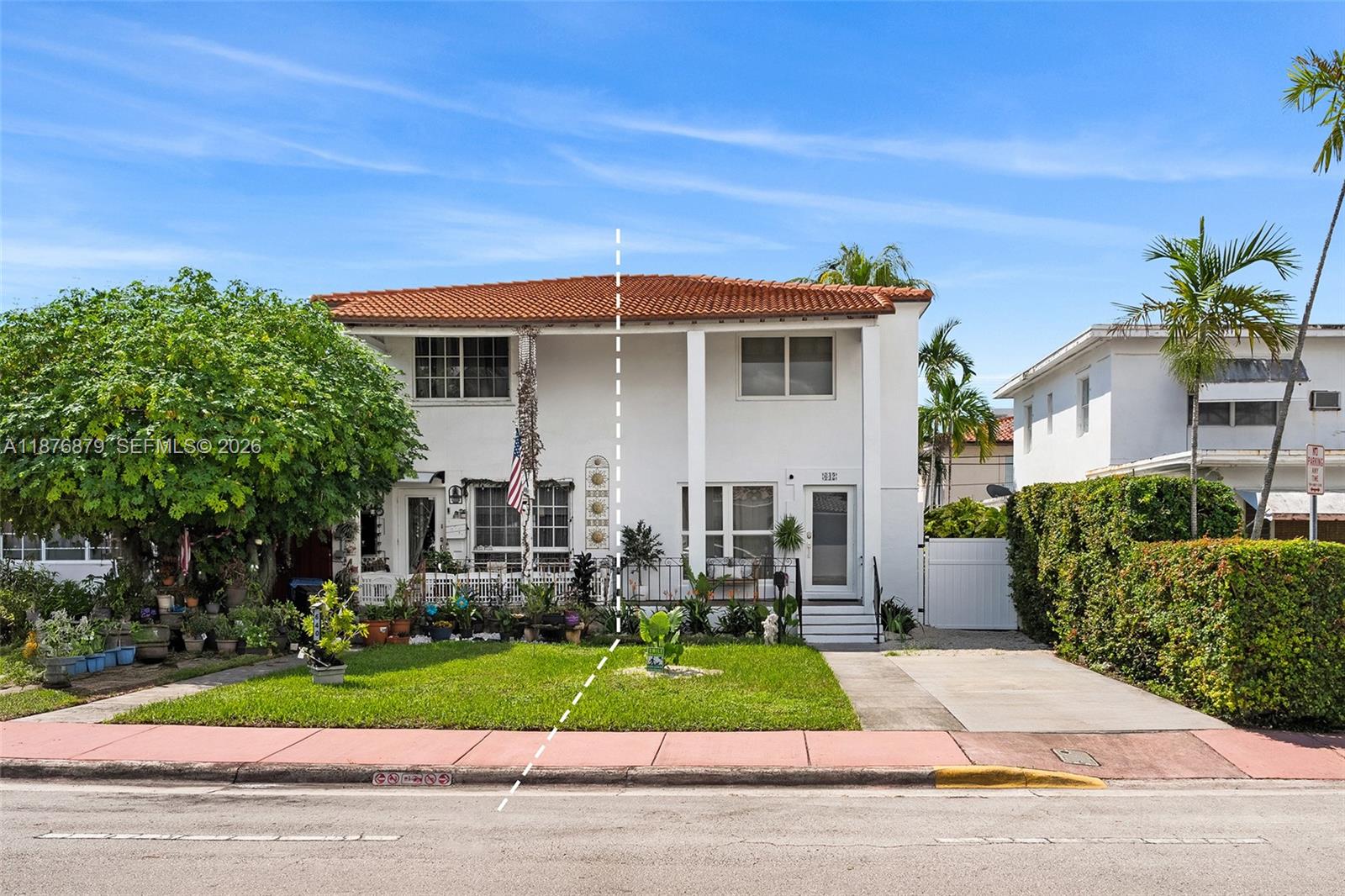 642 86th Street Miami Beach, FL 33141 - Photo 16 of 48 a front view of a house with a yard and potted plants