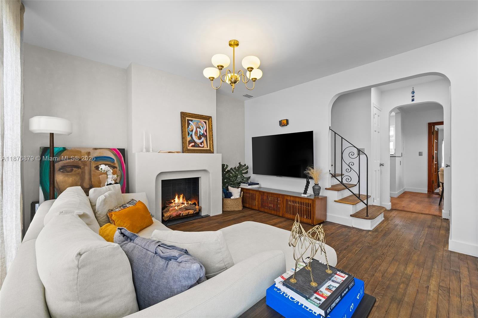 642 86th Street Miami Beach, FL 33141 - Photo 19 of 48 a living room with furniture a fireplace and a flat screen tv