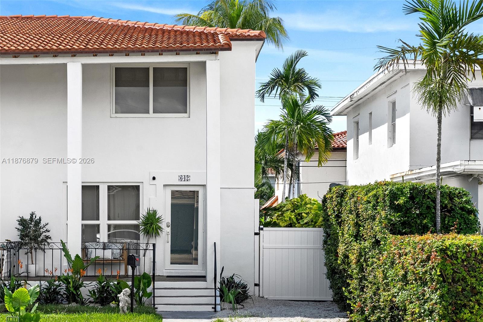 642 86th Street Miami Beach, FL 33141 - Photo 2 of 48 a front view of a house with a garden