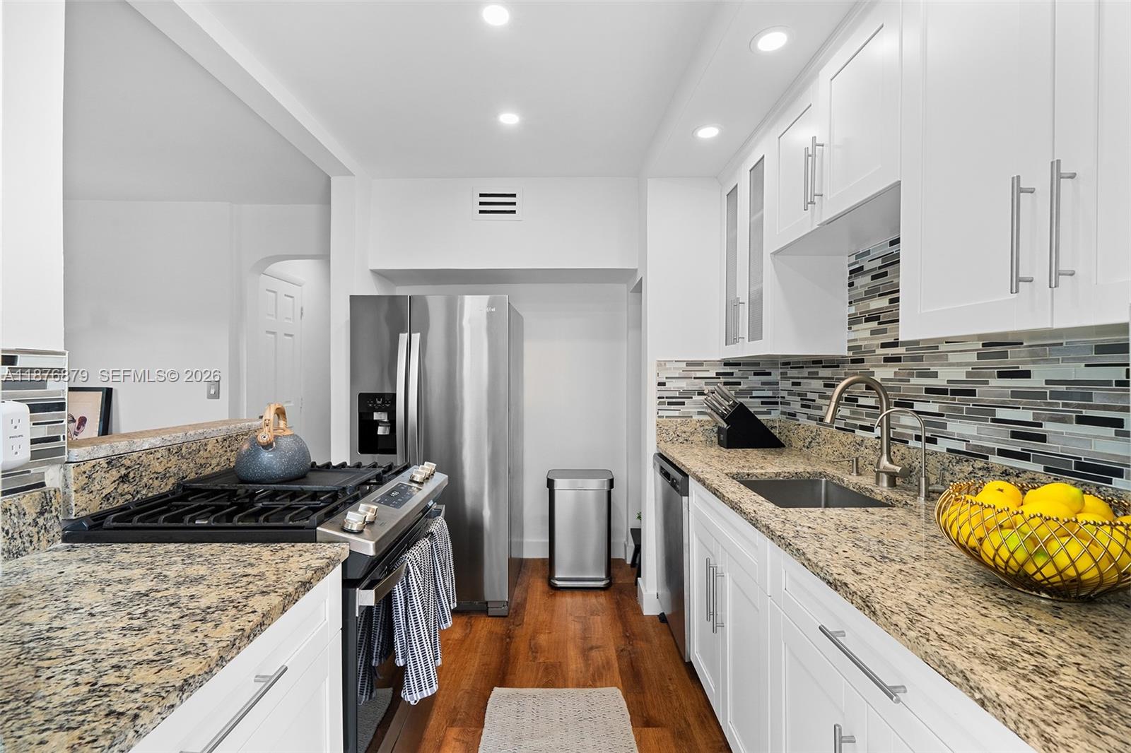 642 86th Street Miami Beach, FL 33141 - Photo 27 of 48 a kitchen with sink stove and refrigerator