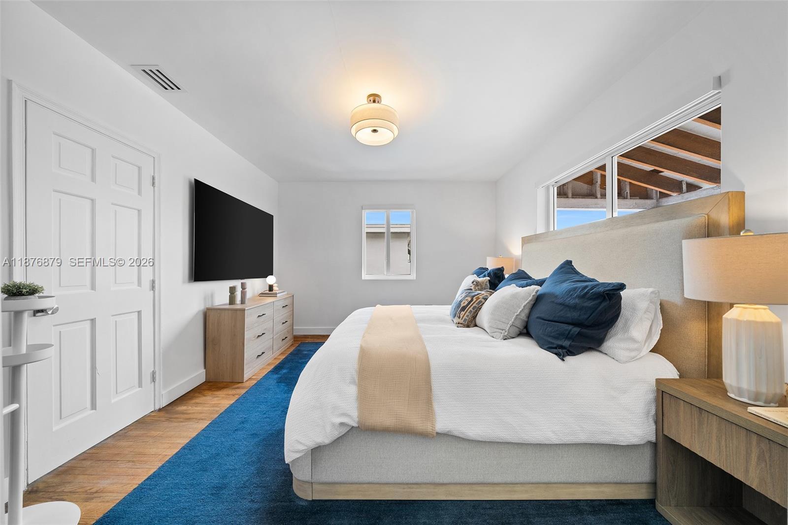 642 86th Street Miami Beach, FL 33141 - Photo 29 of 48 a bedroom with a bed and a flat screen tv