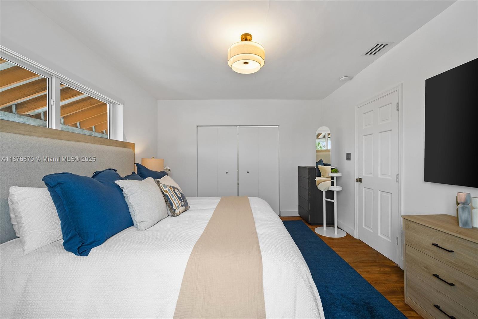 642 86th Street Miami Beach, FL 33141 - Photo 30 of 48 a bedroom with a bed and a flat screen tv