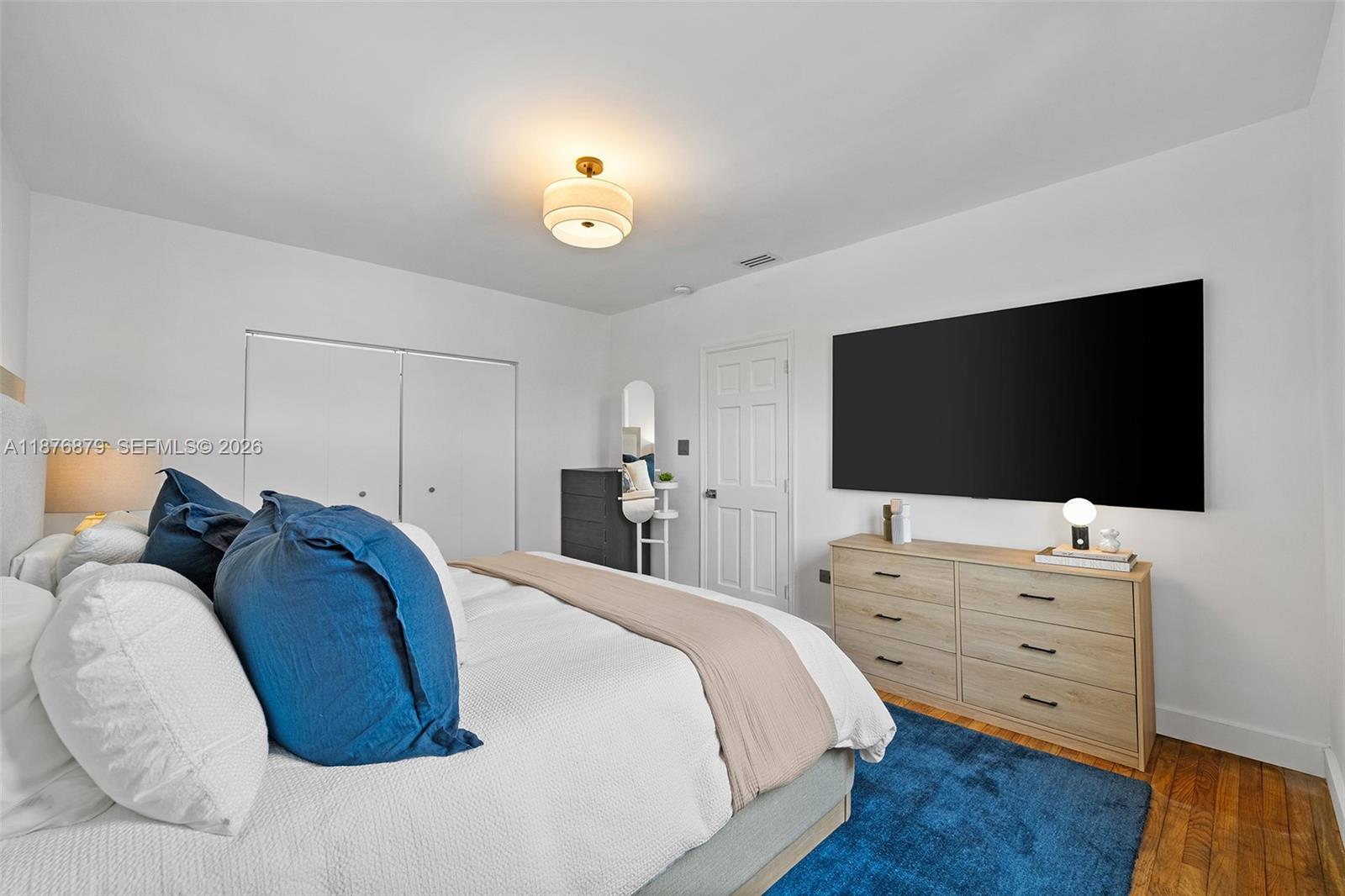 642 86th Street Miami Beach, FL 33141 - Photo 31 of 48 a bedroom with a bed and a flat screen tv