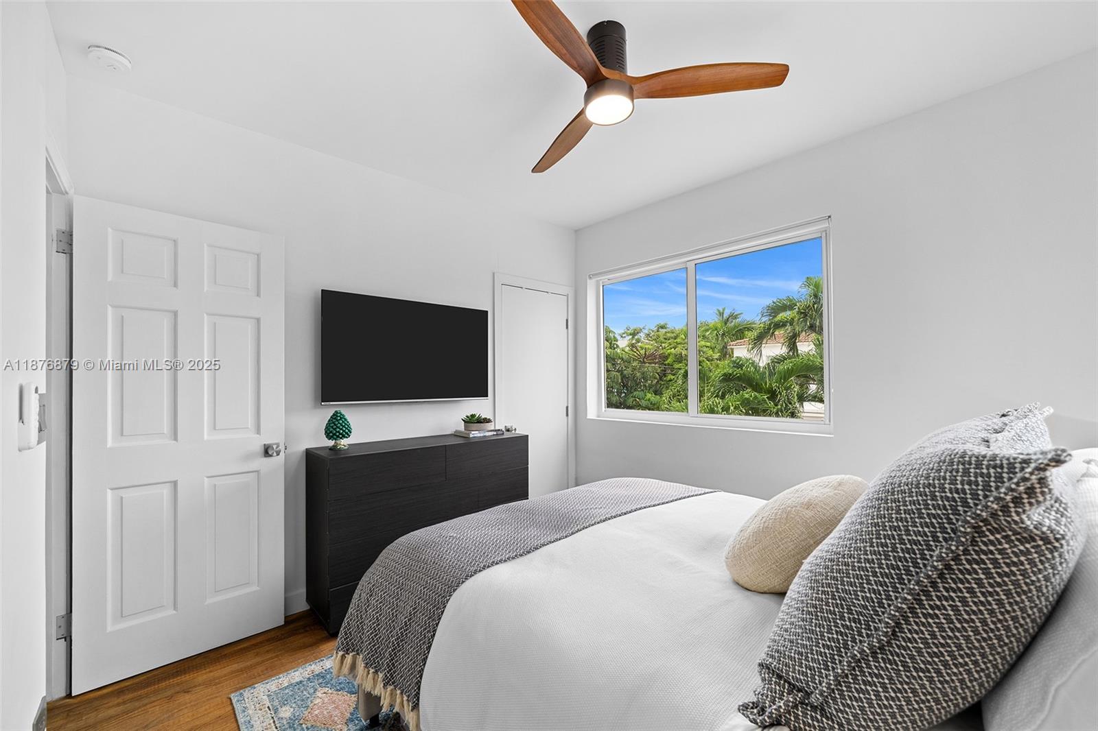 642 86th Street Miami Beach, FL 33141 - Photo 32 of 48 a bedroom with a bed and a flat screen tv