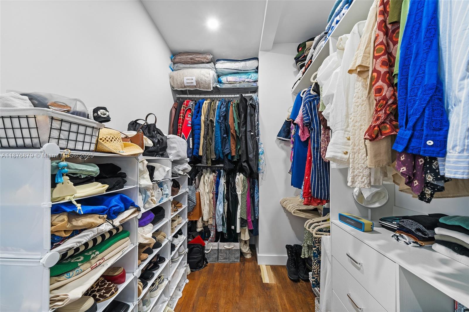 642 86th Street Miami Beach, FL 33141 - Photo 33 of 48 a view of walk in closet with clothes and shoes