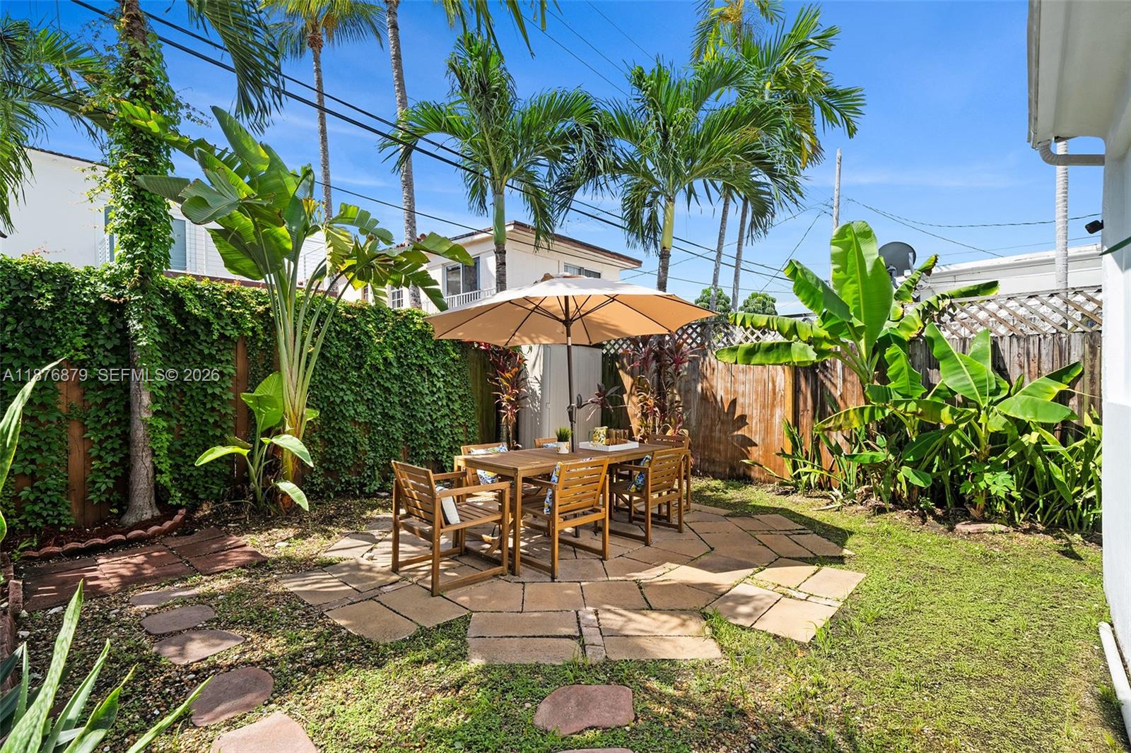 642 86th Street Miami Beach, FL 33141 - Photo 34 of 48 a view of a chairs and table in patio with a backyard