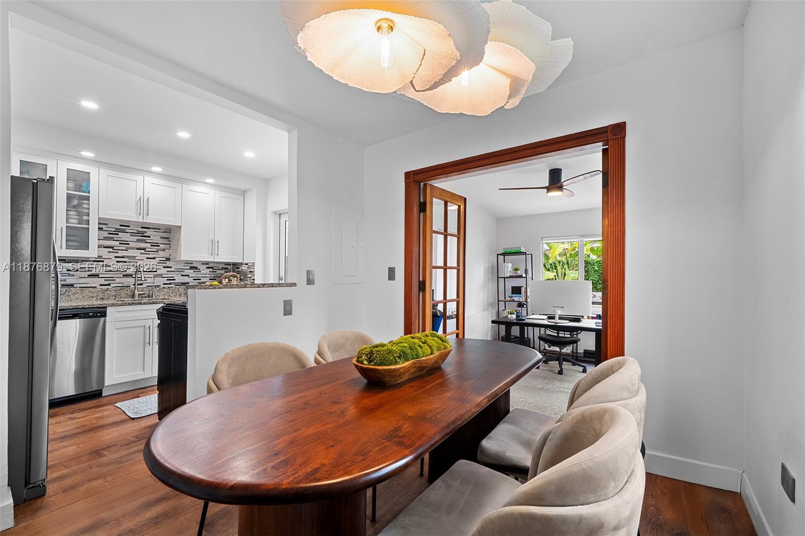 642 86th Street Miami Beach, FL 33141 - Photo 5 of 48 a living room with dining table a table chairs and a chandelier