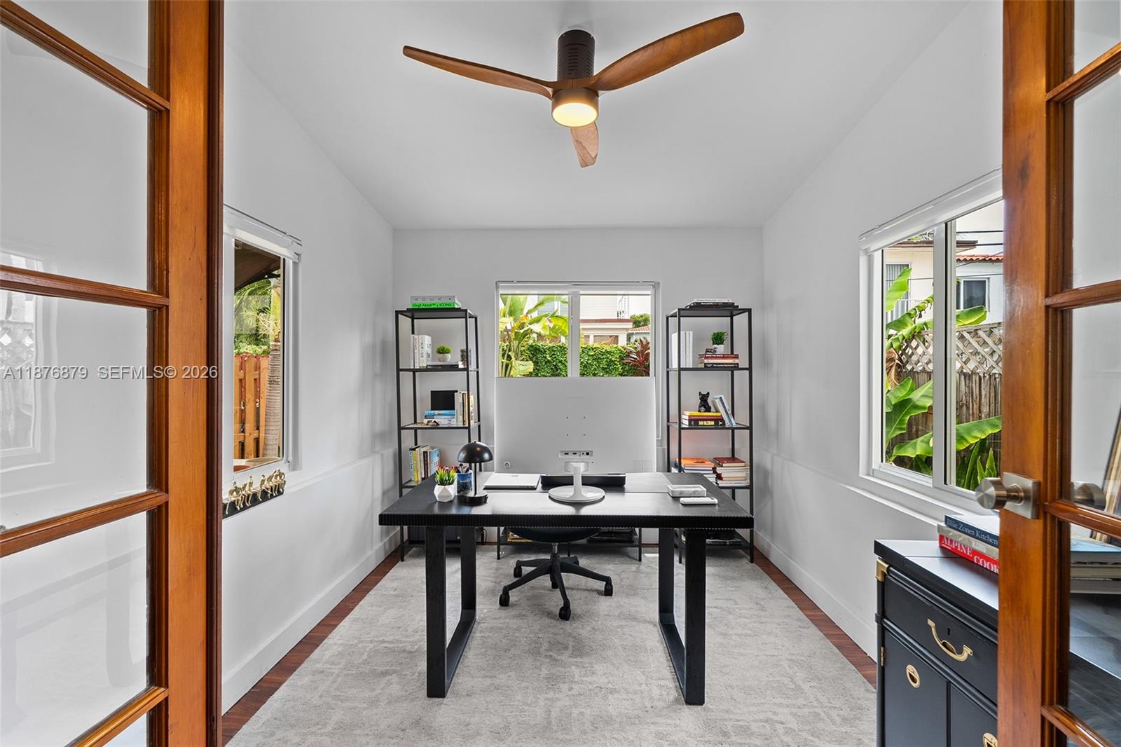 642 86th Street Miami Beach, FL 33141 - Photo 7 of 48 a workspace with furniture and a window