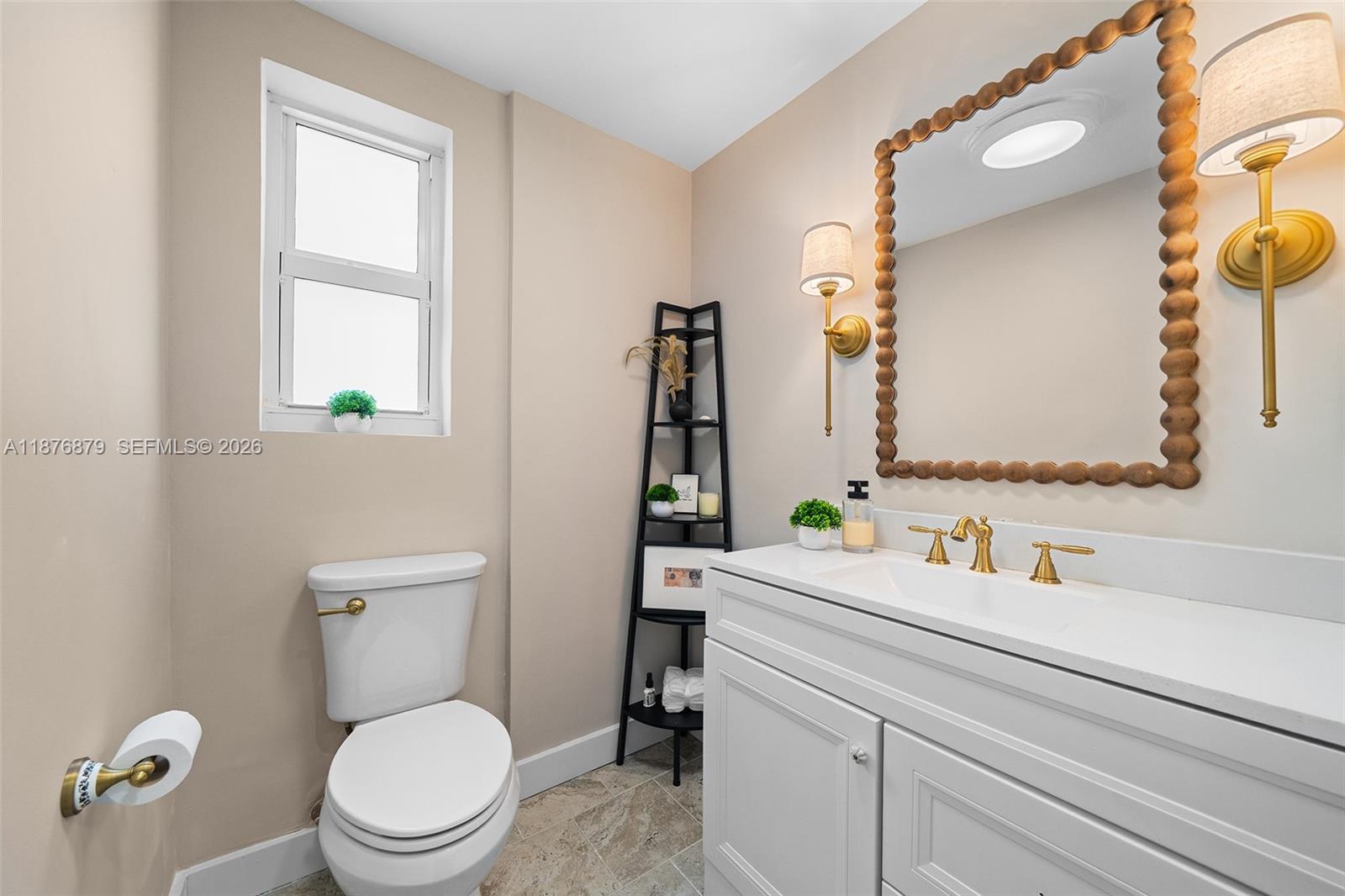 642 86th Street Miami Beach, FL 33141 - Photo 8 of 48 a bathroom with a toilet sink and mirror