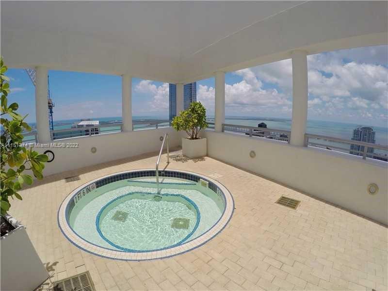 60 Southwest 13th Street, Unit 3003 Miami, FL 33130 - Photo 19 of 22 a bathroom with a tub sink and mirror