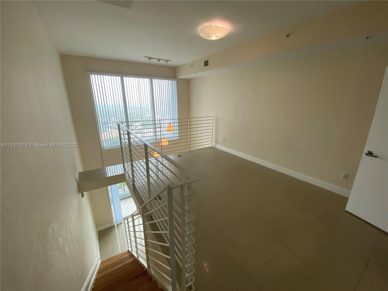 60 Southwest 13th Street, Unit 3003 Miami, FL 33130 - Photo 6 of 22 a view of an empty room with windows