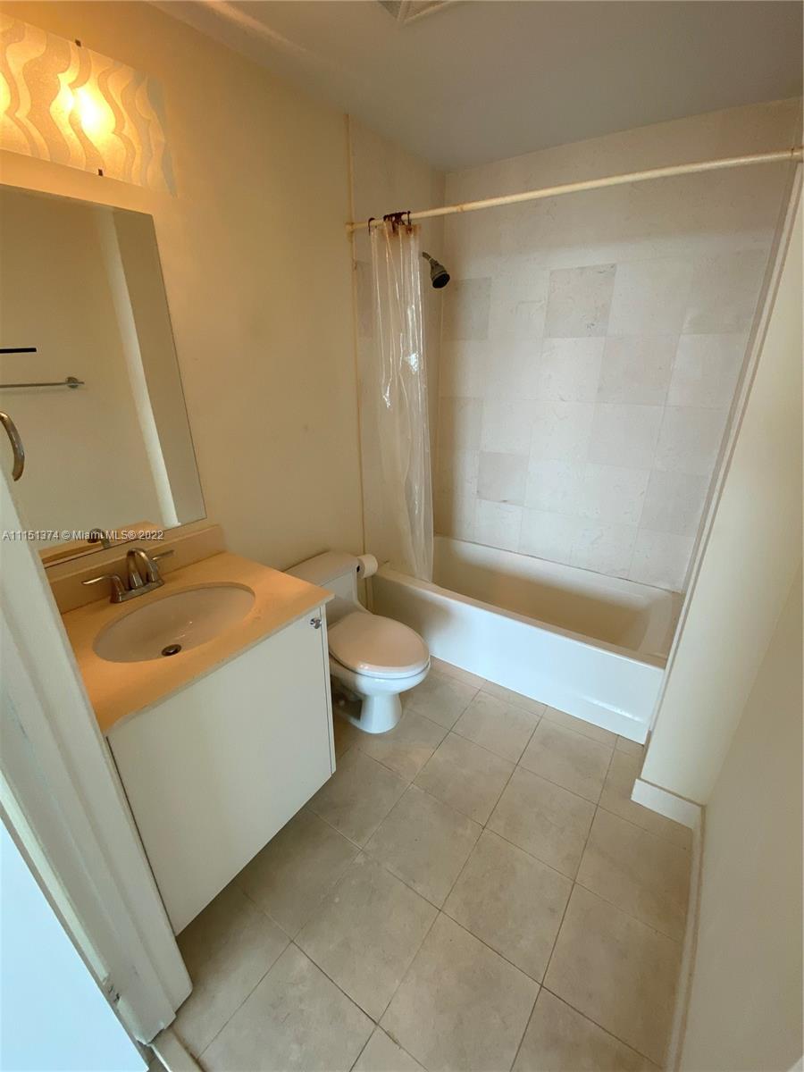 60 Southwest 13th Street, Unit 3003 Miami, FL 33130 - Photo 10 of 22 a bathroom with a sink a toilet and shower