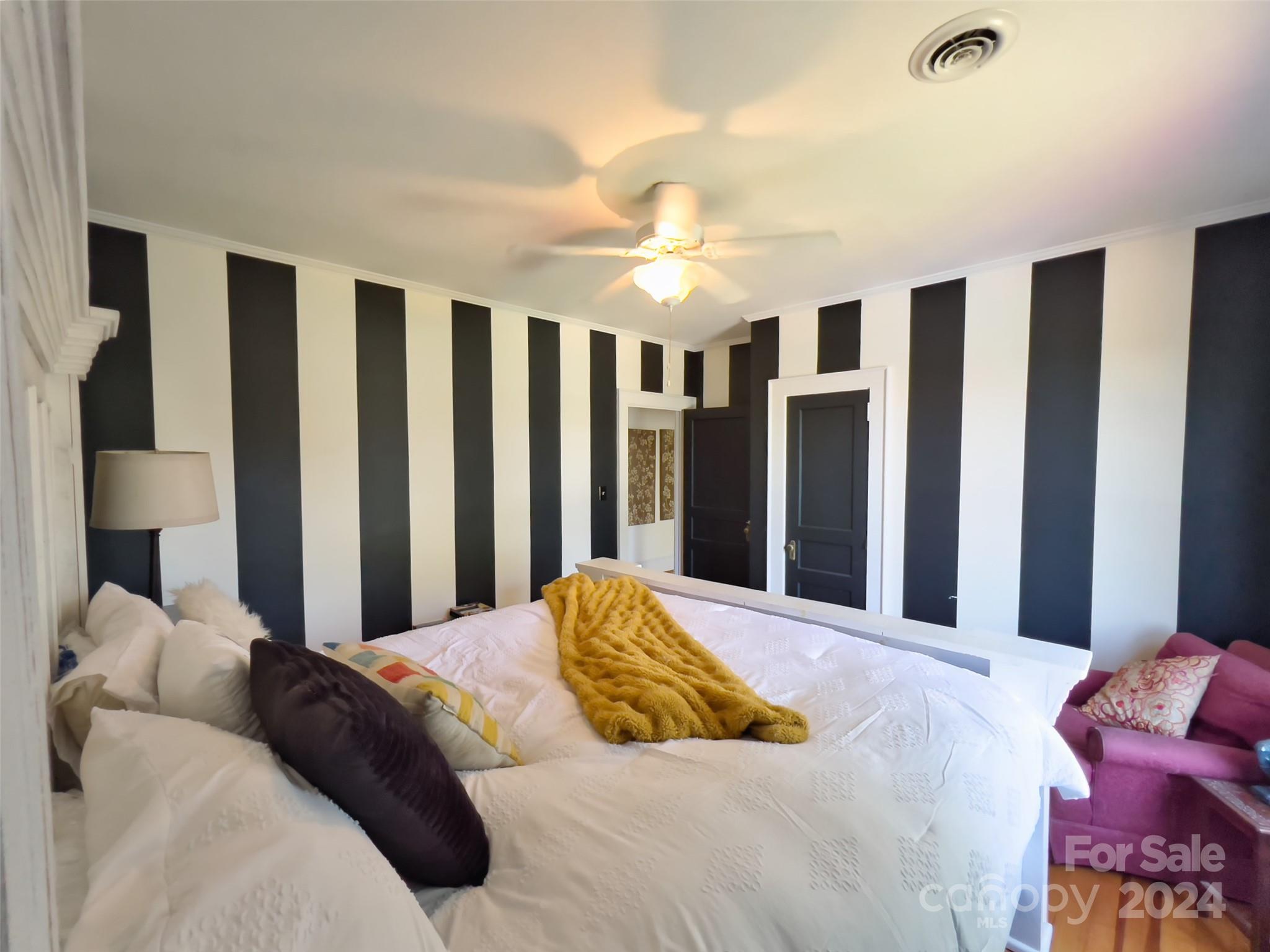 496 Chimney Rock Road Rutherfordton, NC 28139 - Photo 18 of 37 a bedroom with a large bed and a chandelier