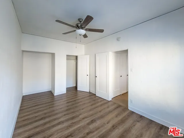 a view of an empty room and wooden floor