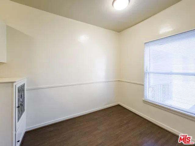 a view of a small space with wooden floor and a window