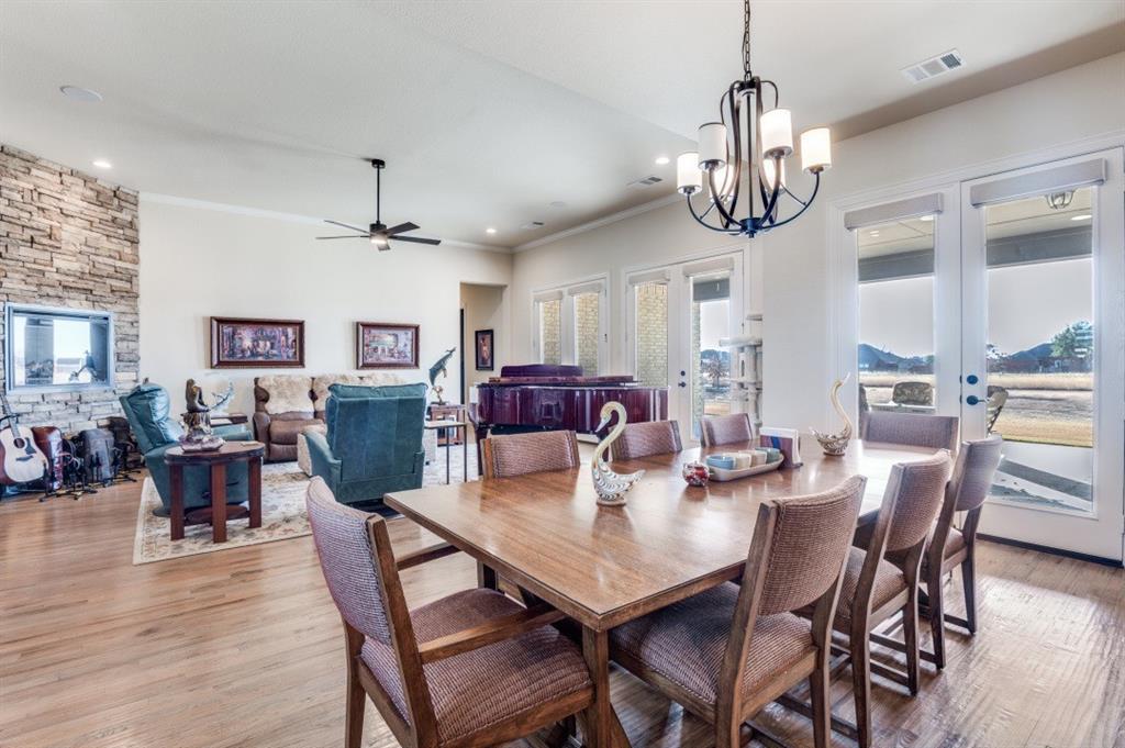 8210 Palmer Road Waxahachie, TX 75167 - Photo 13 of 39 a view of a dining room with furniture wooden floor and chandelier
