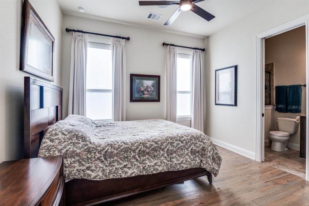 8210 Palmer Road Waxahachie, TX 75167 - Photo 14 of 39 a bedroom with a bed wooden floor and flat screen tv
