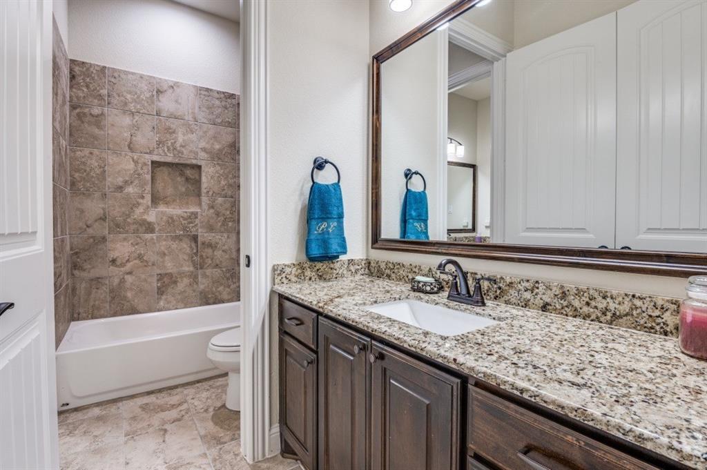 8210 Palmer Road Waxahachie, TX 75167 - Photo 18 of 39 a bathroom with a granite countertop bathtub sink vanity mirror and toilet