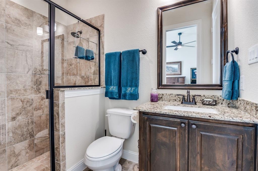 8210 Palmer Road Waxahachie, TX 75167 - Photo 20 of 39 a bathroom with a granite countertop toilet sink and mirror