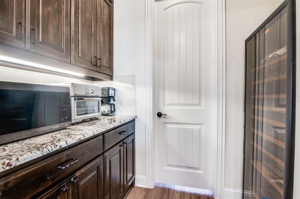 8210 Palmer Road Waxahachie, TX 75167 - Photo 29 of 39 a kitchen with stainless steel appliances granite countertop a refrigerator and a sink