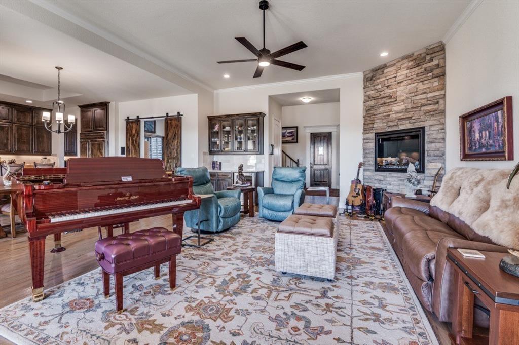 8210 Palmer Road Waxahachie, TX 75167 - Photo 5 of 39 a living room with furniture a fireplace and a flat screen tv