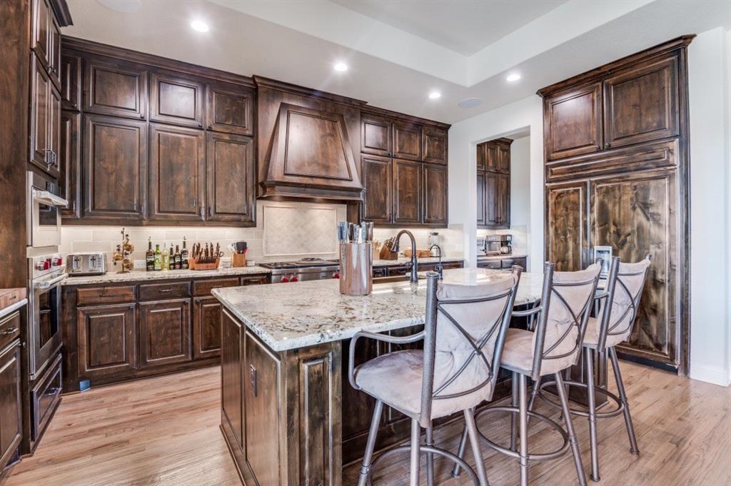 8210 Palmer Road Waxahachie, TX 75167 - Photo 10 of 39 a kitchen with granite countertop a sink stove and refrigerator