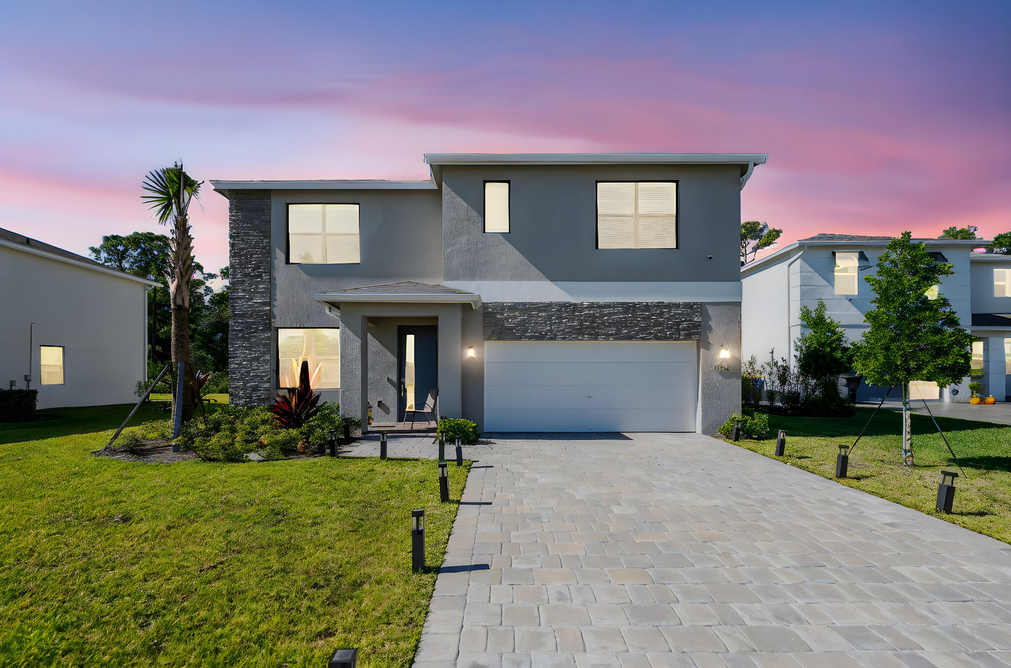 a front view of a house with a yard and garage