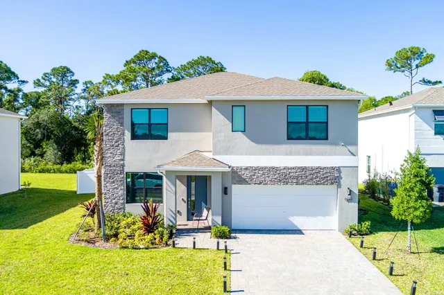 a bedroom with a bed a dresser and a window