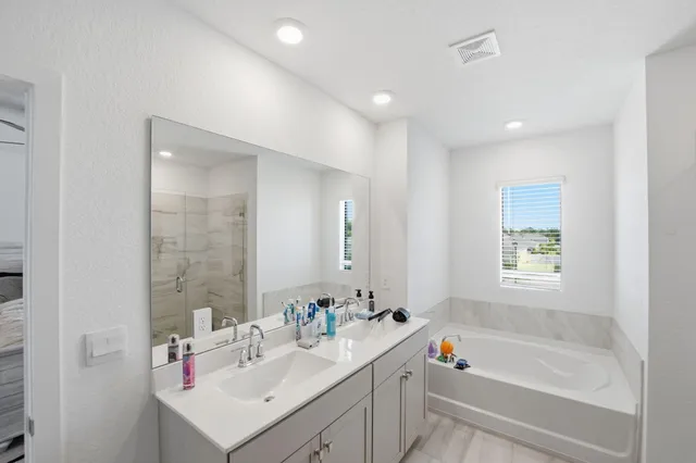 a front view of house with yard and trees in the background