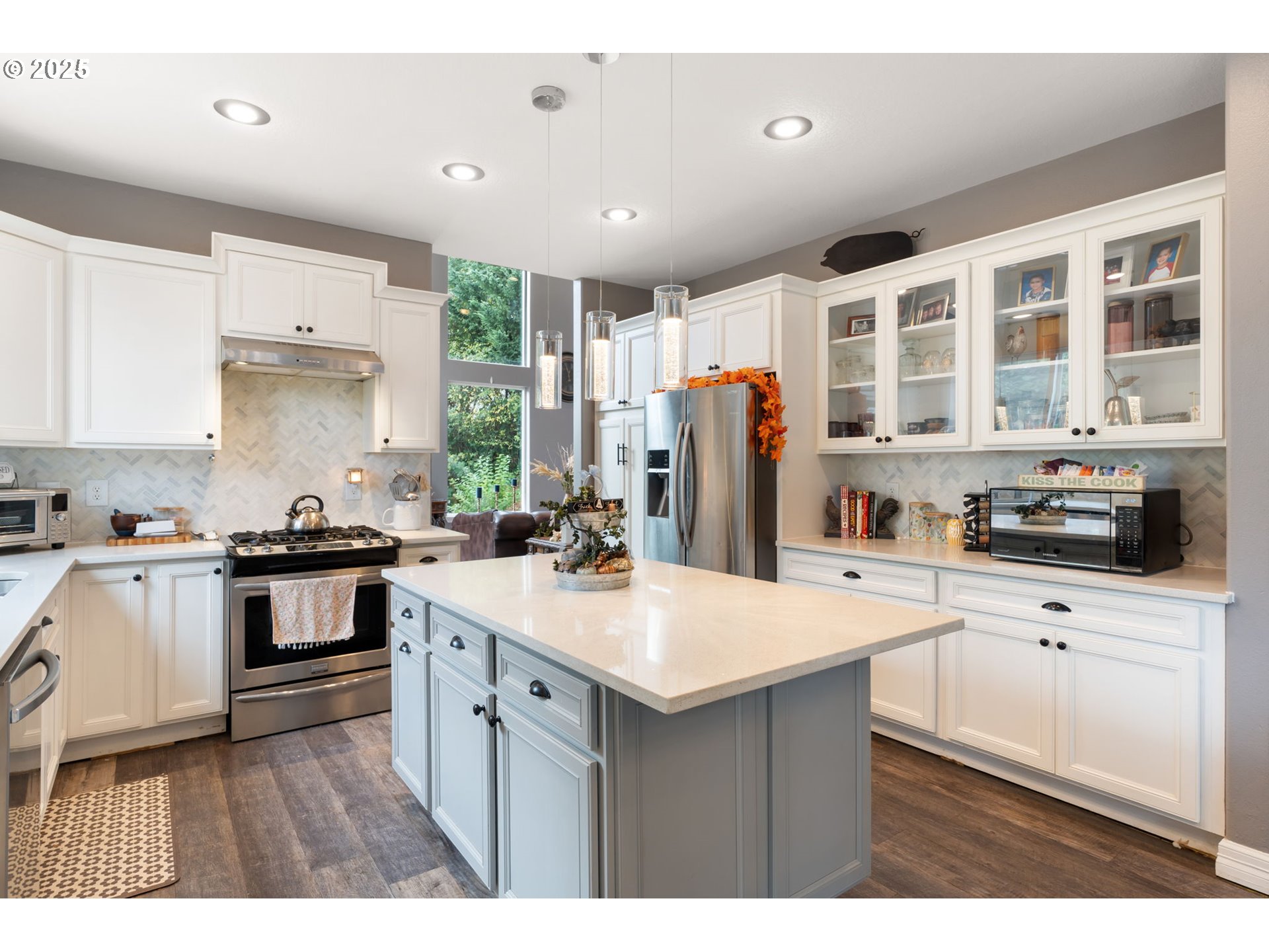 117 Altavista Road Longview, WA 98632 - Photo 13 of 40 a kitchen with stainless steel appliances kitchen island granite countertop a refrigerator a stove a sink dishwasher and white cabinets with wooden floor