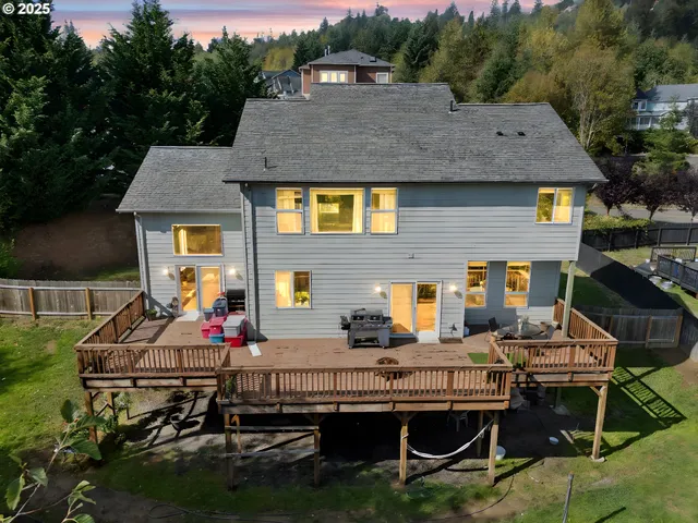a view of a house with backyard and sitting area