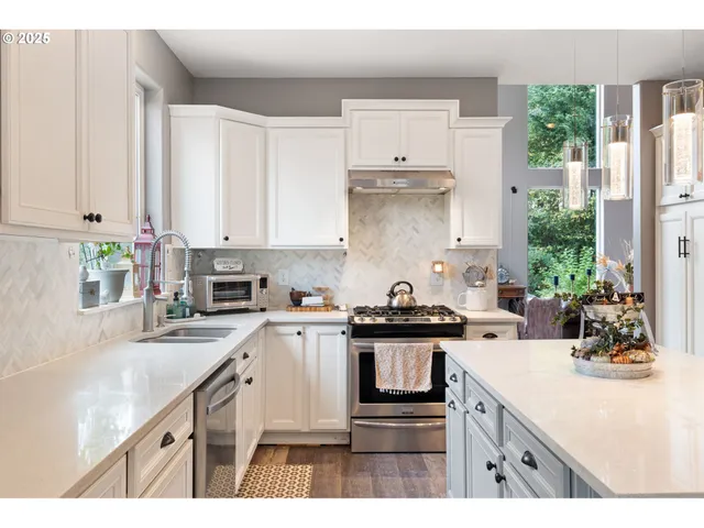 a kitchen with kitchen island granite countertop a sink a stove and cabinets
