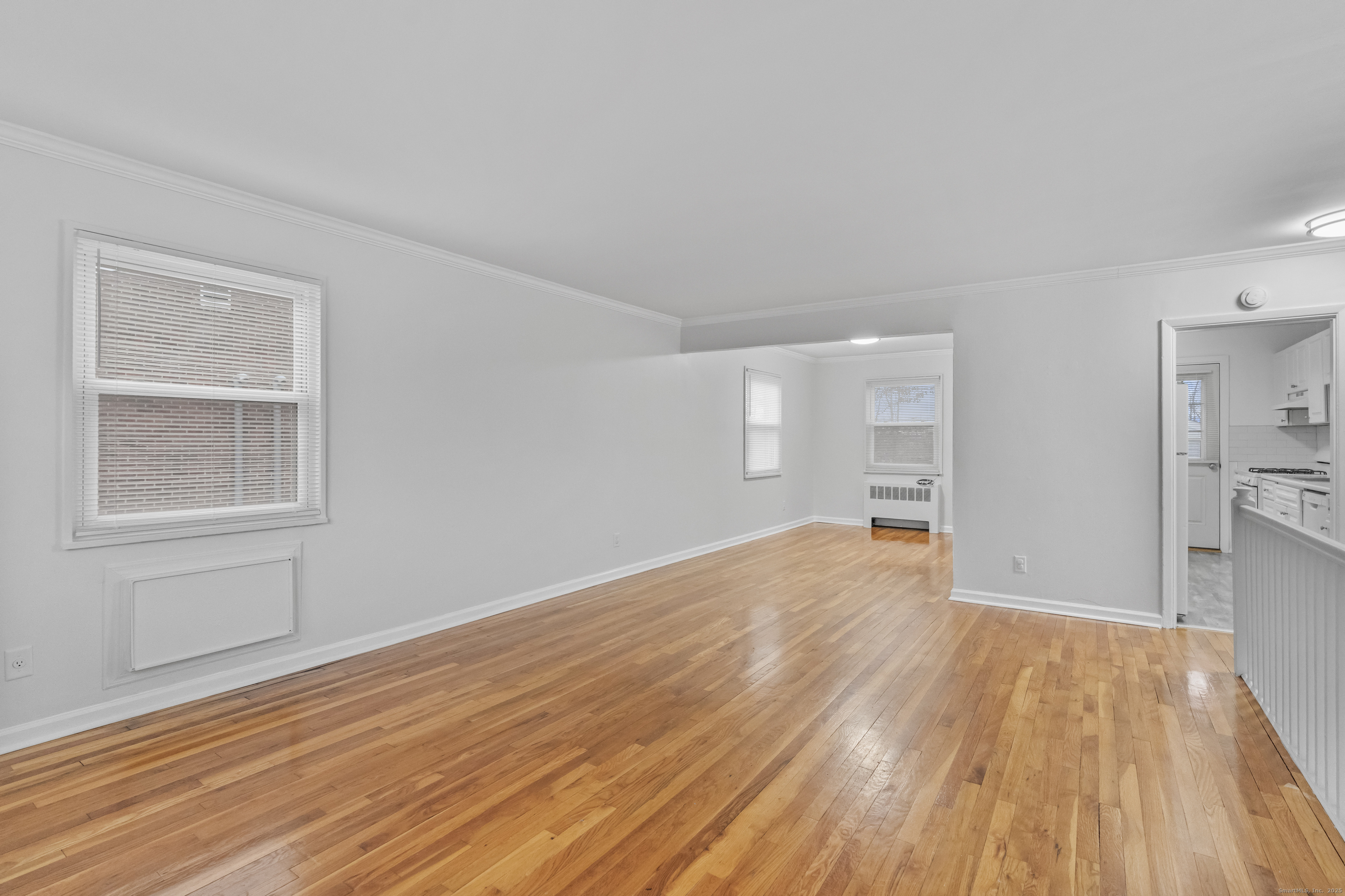 56 Blachley Road, Unit B Stamford, CT 06902 - Photo 4 of 26 a view of empty room with wooden floor and fan