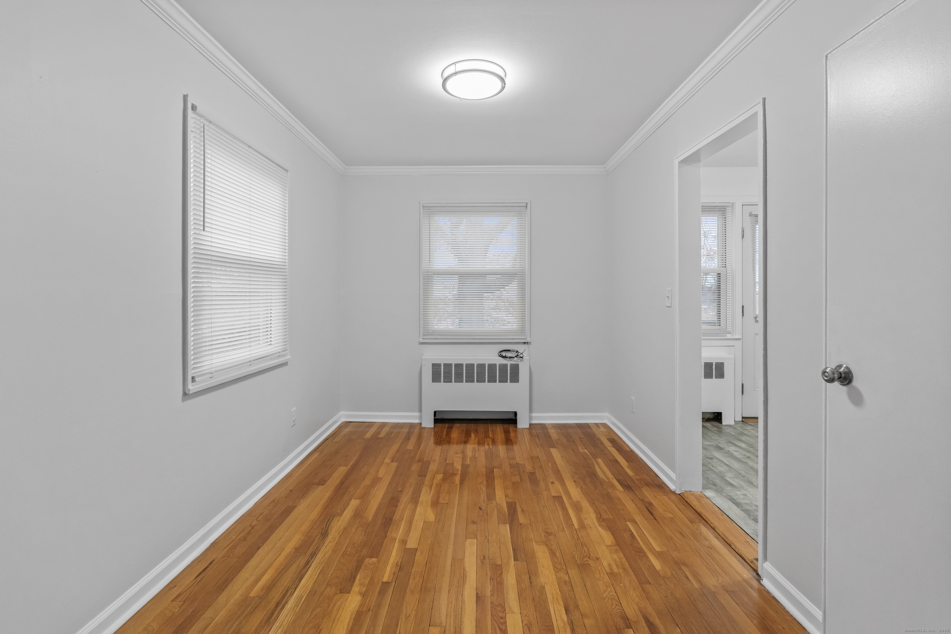 56 Blachley Road, Unit B Stamford, CT 06902 - Photo 6 of 26 a view of a room with wooden floor window and closet