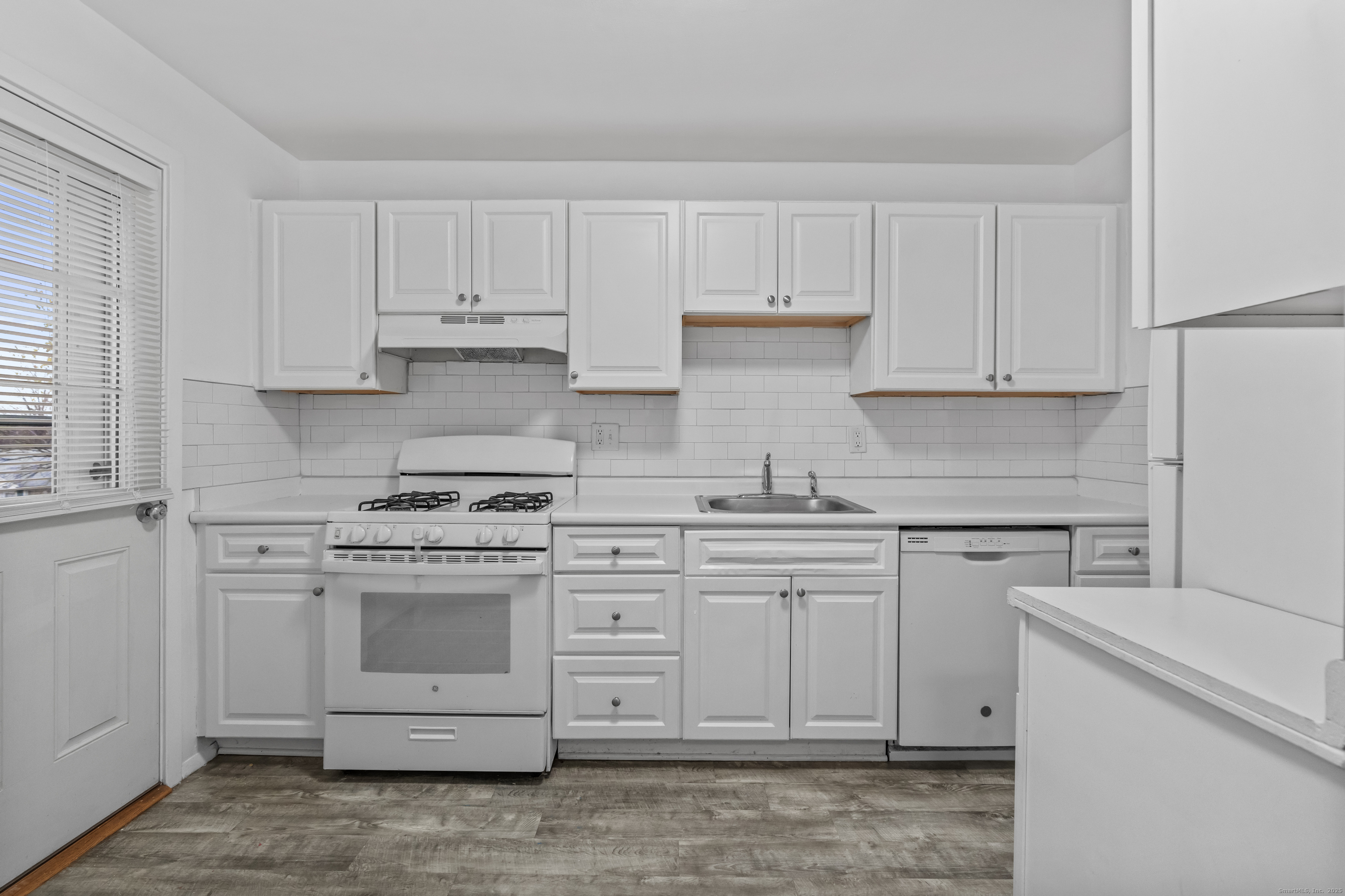 56 Blachley Road, Unit B Stamford, CT 06902 - Photo 7 of 26 a kitchen with cabinets appliances and a sink