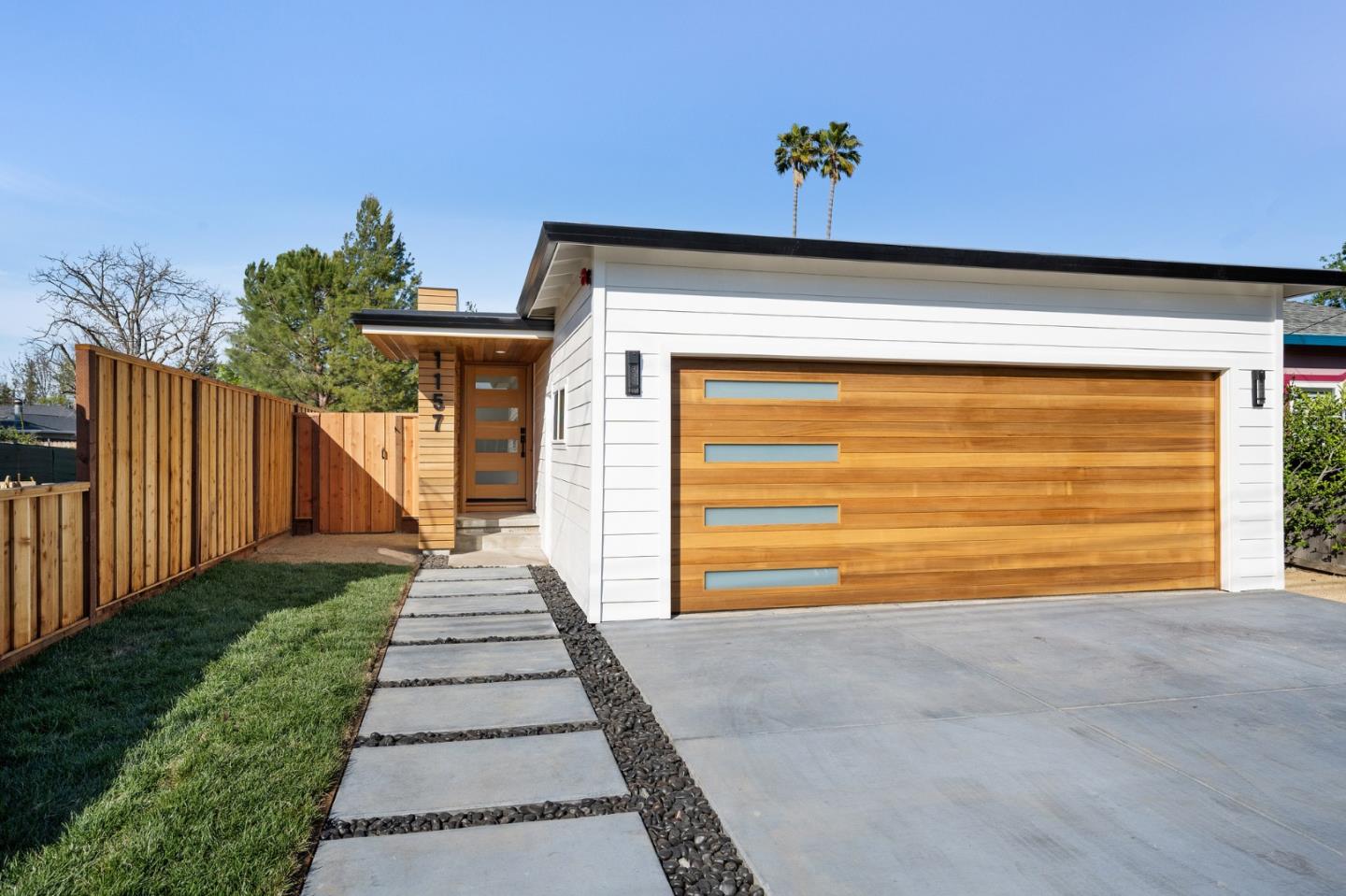 1157 Ruby Street Redwood City, CA 94061 - Photo 1 of 31 a front view of a house with a yard and garage
