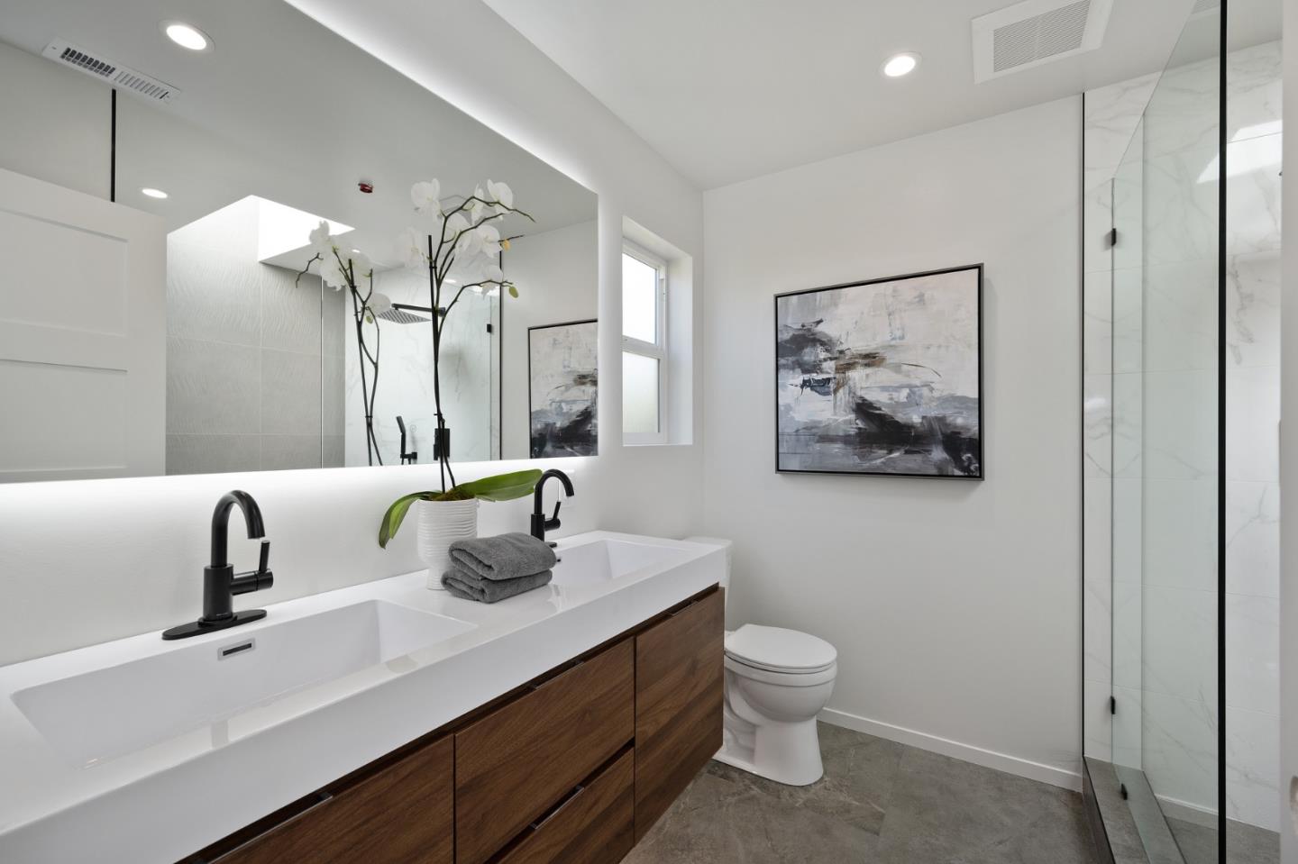 1157 Ruby Street Redwood City, CA 94061 - Photo 17 of 31 a bathroom with a toilet sink and mirror