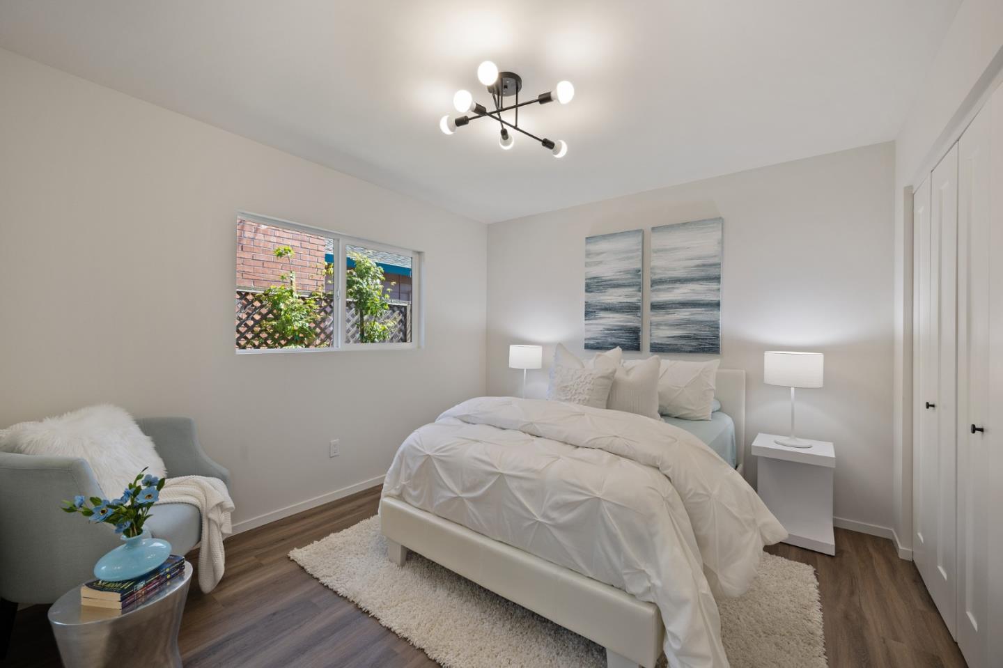 1157 Ruby Street Redwood City, CA 94061 - Photo 22 of 31 a bedroom with a bed and a chandelier