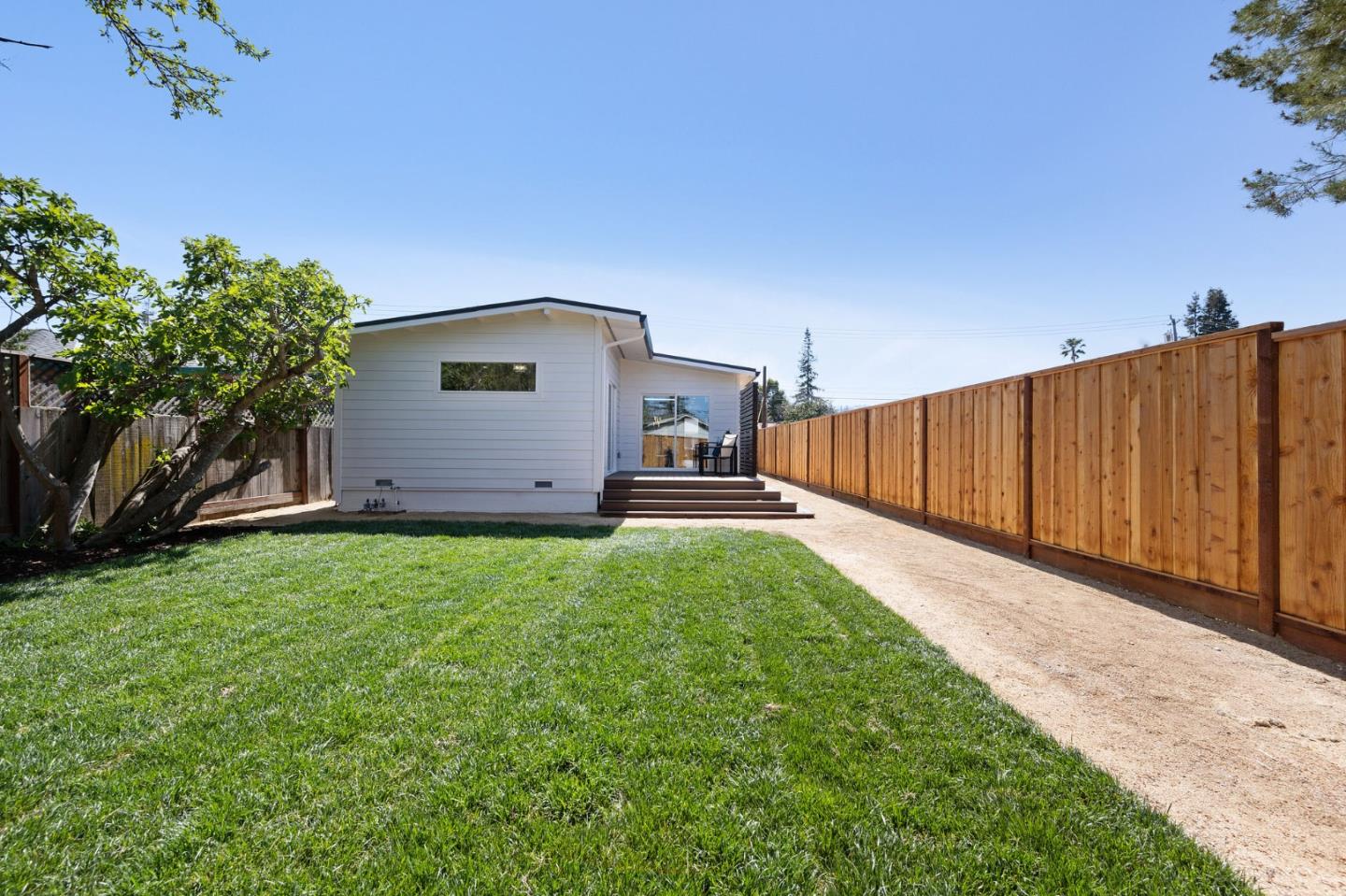 1157 Ruby Street Redwood City, CA 94061 - Photo 27 of 31 a view of a backyard with potted plants and wooden fence